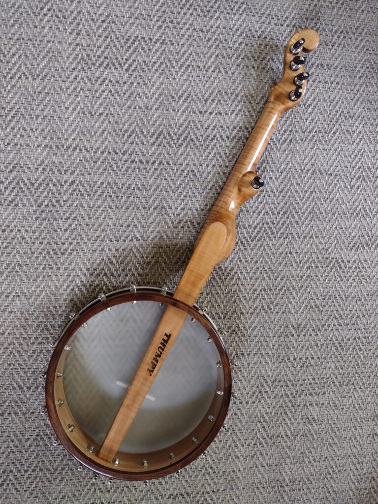 A five string banjo as seen from the back